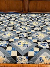 Beautiful blue floral design with intricate squares and diamonds shapes and patterns.